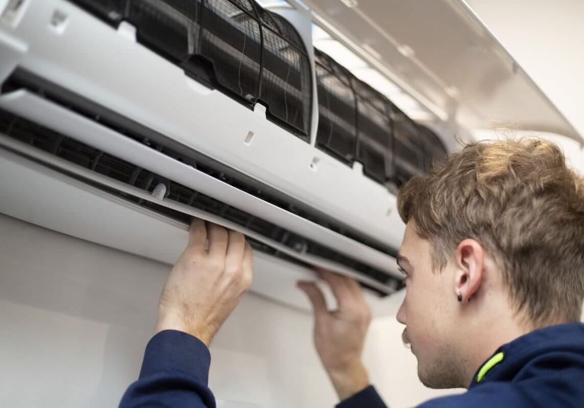 A professional technician conducting Air Conditioning Repairs, ensuring optimal performance of the aircon unit.